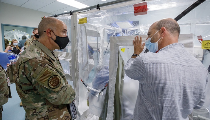 Image with caption: At right, David Brett-Major, MD, one of the newly named Global Center for Health Security scholars, talks with Lt. Gen. Robert Miller, surgeon general for the U.S. Air Force,  during a 2021 tour of UNMC's Davis Global Center.